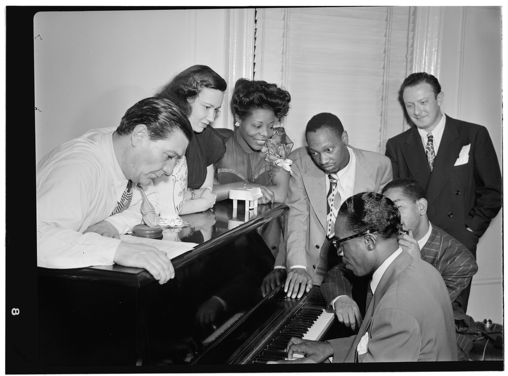 Portrait of Jack Teagarden, Dixie Bailey, Mary Lou Williams, Tadd Dameron, Hank Jones, Dizzy Gillespie, and Milt Orent, Mary Lou Williams' apartment, New York, N.Y., ca. Aug. 1947 [Gottlieb Collection Assignment No. 338]